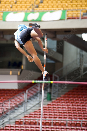 Photo: Image of a female pole vaulter in action. Image of a female pole vaulter in action.