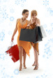 happy ladies with shopping bags and snowflakes