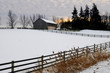 Farm with a barn and horses in winter at sunset Farm with a barn and horses in winter at sunset