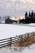 Farm with a barn and horses in winter at sunset Farm with a barn and horses in winter at sunset