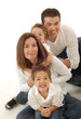Family having fun on the floor, hugging and smiling