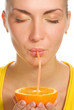 Beautiful girl drinks natural orange juice