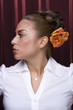 Female model with styled hair on red background.