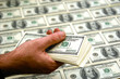 man holding a stack of fresh new crisp hundred dollar bills man holding a stack of fresh new crisp hundred dollar bills