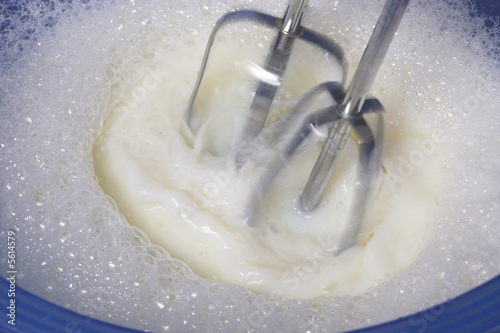 Photo: The beaters of a mixer making milk foam. The beaters of a mixer making milk foam.