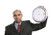young handsome business man holding a clock