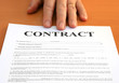 Photo: Male hand presents a contract document Male hand presents a contract document