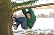 Boy Climbing a Tree in Winter Boy Climbing a Tree in Winter