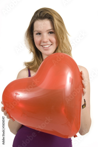 a cute girl with a heart shaped balloon for valentine's day