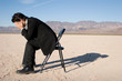 Businessman sitting alone in the empty desert