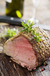 nice piece of roasted siroin beef covered in herbs