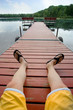 Man relaxing on a dock by small lake