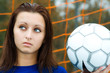 A beautiful soccer player holding a soccer ball