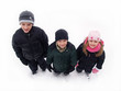 three children standing in the snow