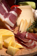Farmers plate at sea with cheeses, prosciutto and olives Farmers plate at sea with cheeses, prosciutto and olives