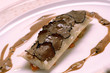 Fish steak on vegetables with truffle slices on top Fish steak on vegetables with truffle slices on top