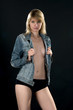 Young attractive woman in studio over black background