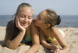 Two girls play on a beach