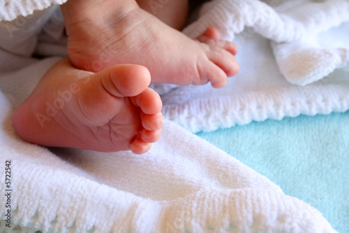 Photo: New Born Feet wrapped in a soft white blanket New Born Feet wrapped in a soft white blanket