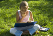 The girl draws on a meadow V