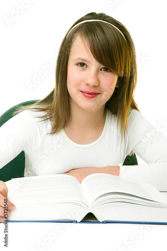 Photo: Portrait of Happy young schoolgirl reading book Portrait of Happy young schoolgirl reading book