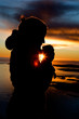 Photo: A person standing by the Ocean drink a warm drink at sundown A person standing by the Ocean drink a warm drink at sundown