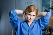 Pretty redhead in blue male shirt smiling