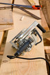 A workman's circular saw sitting on a piece of lumber