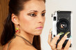 Sexy girl with old photo camera taking a shoot. Sexy girl with old photo camera taking a shoot.