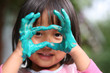 child painting with hands and playing with colours