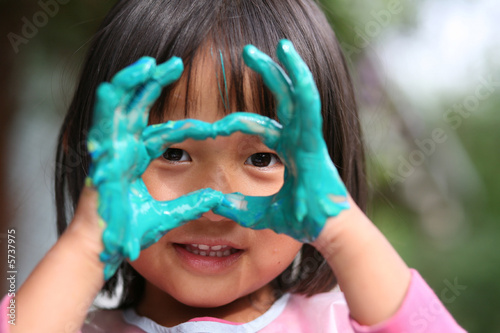 Photo: child painting with hands and playing with colours child painting with hands and playing with colours