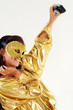 Sexy smiling girl in golden mask with old photo camera. Sexy smiling girl in golden mask with old photo camera.