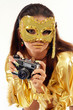 Sexy girl in golden mask & dress with old photo camera. Sexy girl in golden mask & dress with old photo camera.