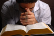 holy bible open with a cross on a hand