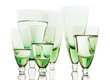 Photo: A glass beside a stack of white plates - on white background A glass beside a stack of white plates - on white background