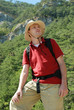 Hiker in mountains against green forest