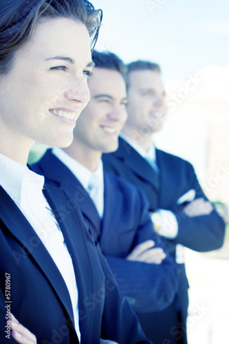 Photo: one female two males wearing dark business suits one female two males wearing dark business suits