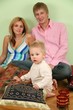 family sit on floor on pillow 2