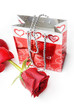 Red rose and package with hearts as a gift for Valentine day
