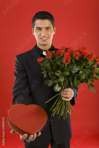 Photo: Handsome businessman, with bouquet of roses Handsome businessman, with bouquet of roses