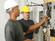 An african american and a caucasian electrician working 