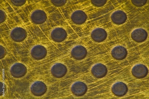 Photo: Punched Brass Metallic Background Punched Brass Metallic Background