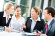 Photo: Business people sitting at the table and discussing a project Business people sitting at the table and discussing a project