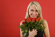 Beautiful woman in black dress, holding bouquet of roses.