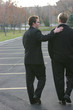 Foto: Two business men walking in parking lot Two business men walking in parking lot