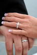 Left hands posed to display wedding rings. Left hands posed to display wedding rings.