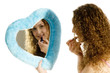 Attractive girl is working with lipstick in Valentines mirror