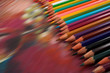 Assortment of coloured pencils on draw background