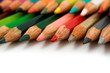 Assortment of coloured pencils with shadow on white background