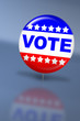 Election day vote button with reflection on a table